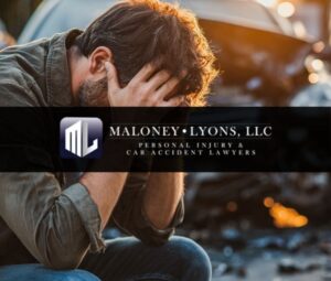 man outside of his car holding his head in pain after a car crash in biloxi mississipi