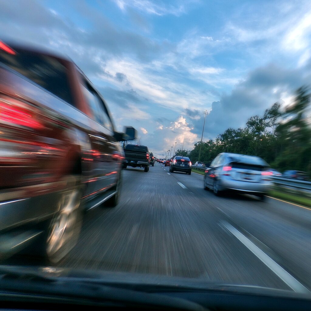 Driver with road rage in a Ford F150 tailgating another driver in a Toyota Prius in Biloxi, Mississippi